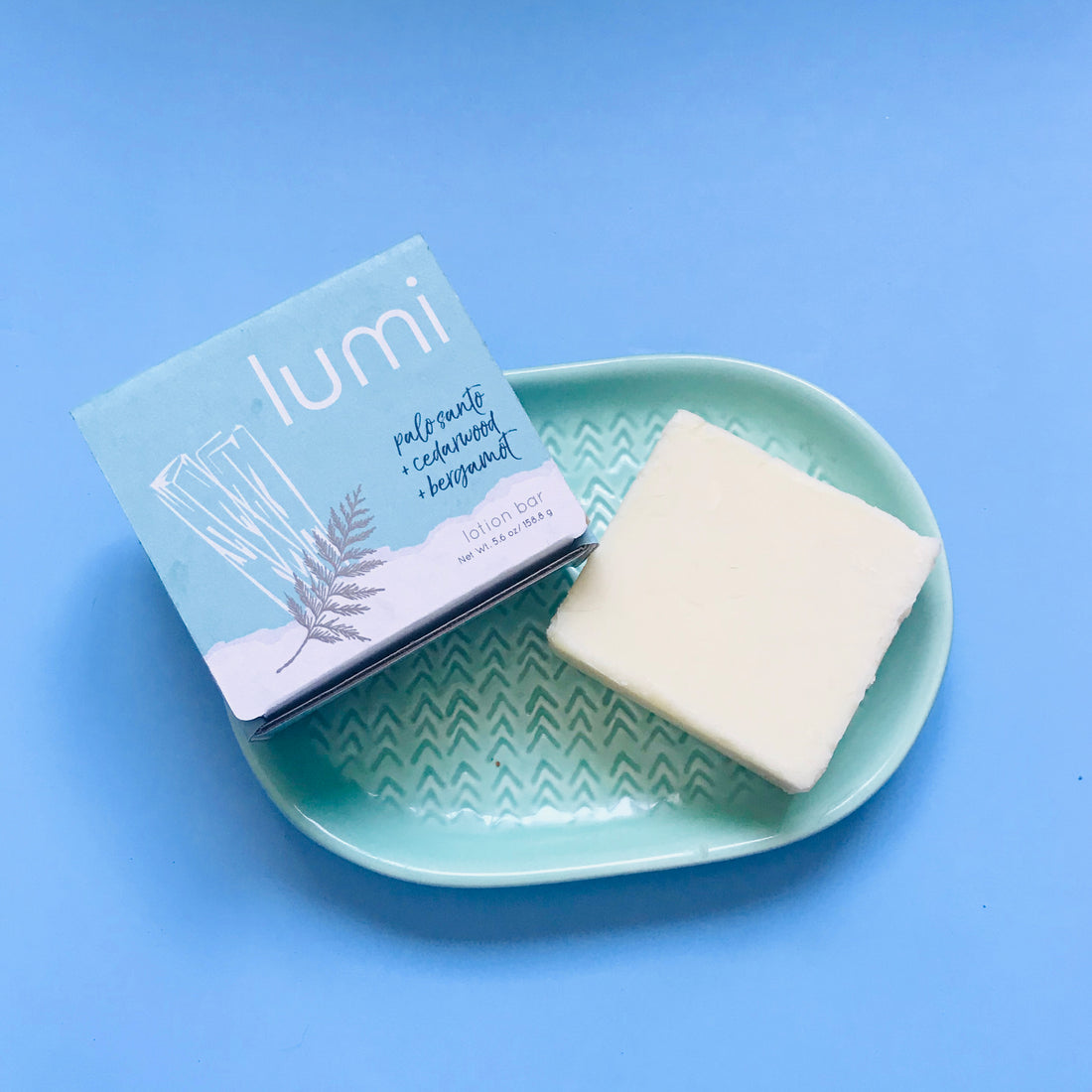 lotion bar with packaging on dish